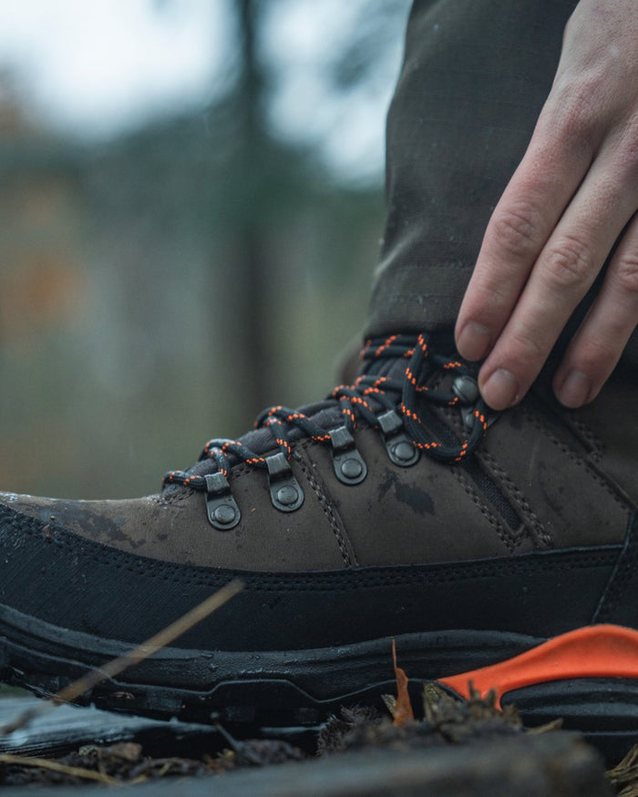 Dark Brown coloured Seeland Enduro Tracker High Boots on forest background #colour_dark-brown