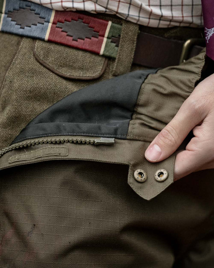 Shaded Olive coloured Seeland Mens Buckthorn Duro Overtrousers on forest background #colour_shaded-olive