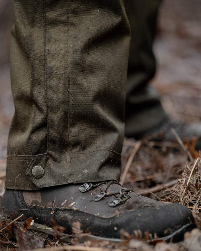 Shaded Olive coloured Seeland Mens Buckthorn Duro Overtrousers on forest background #colour_shaded-olive