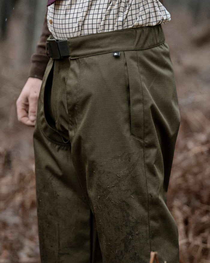 Shaded Olive coloured Seeland Mens Buckthorn Duro Treggings on forest background #colour_shaded-olive