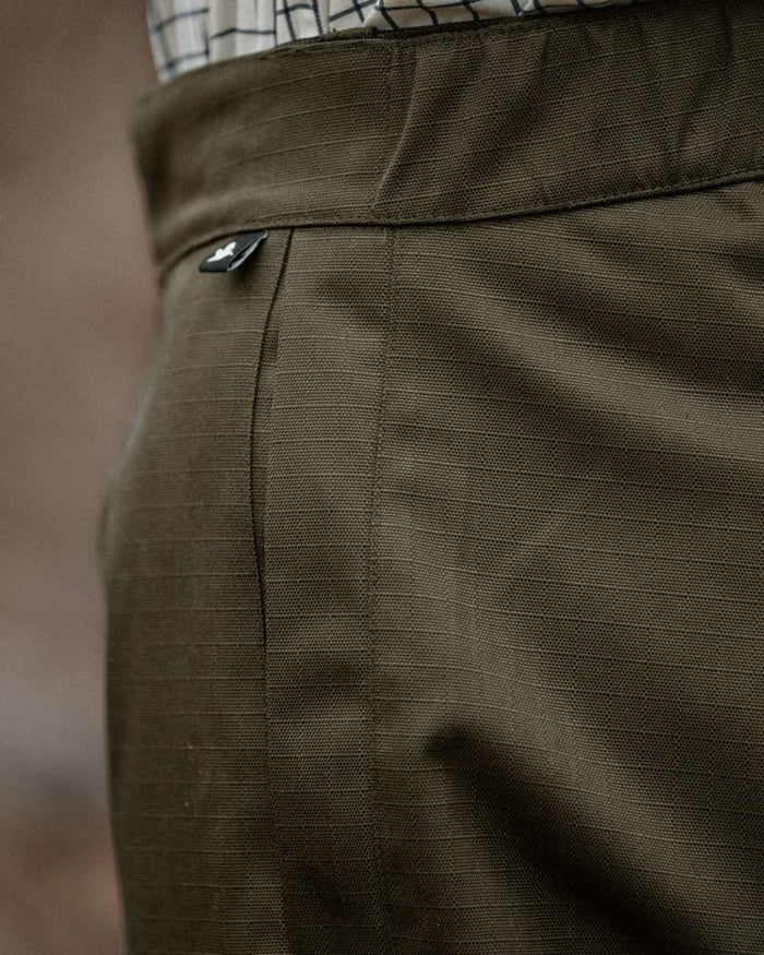 Shaded Olive coloured Seeland Mens Buckthorn Duro Treggings on forest background #colour_shaded-olive