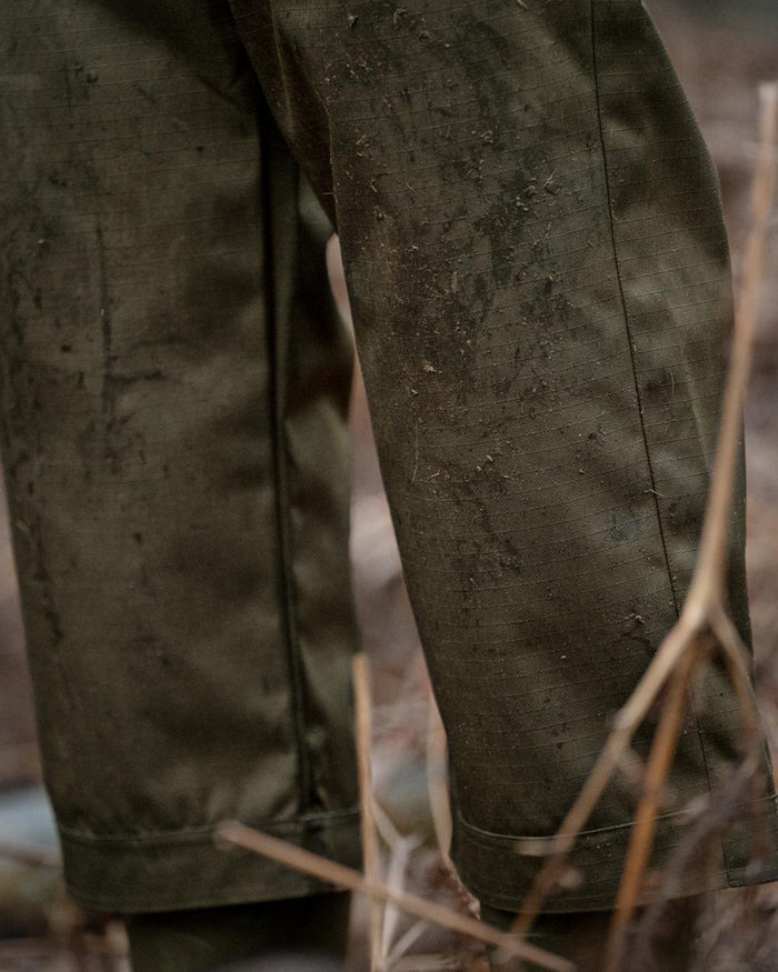 Shaded Olive coloured Seeland Mens Buckthorn Duro Treggings on forest background #colour_shaded-olive
