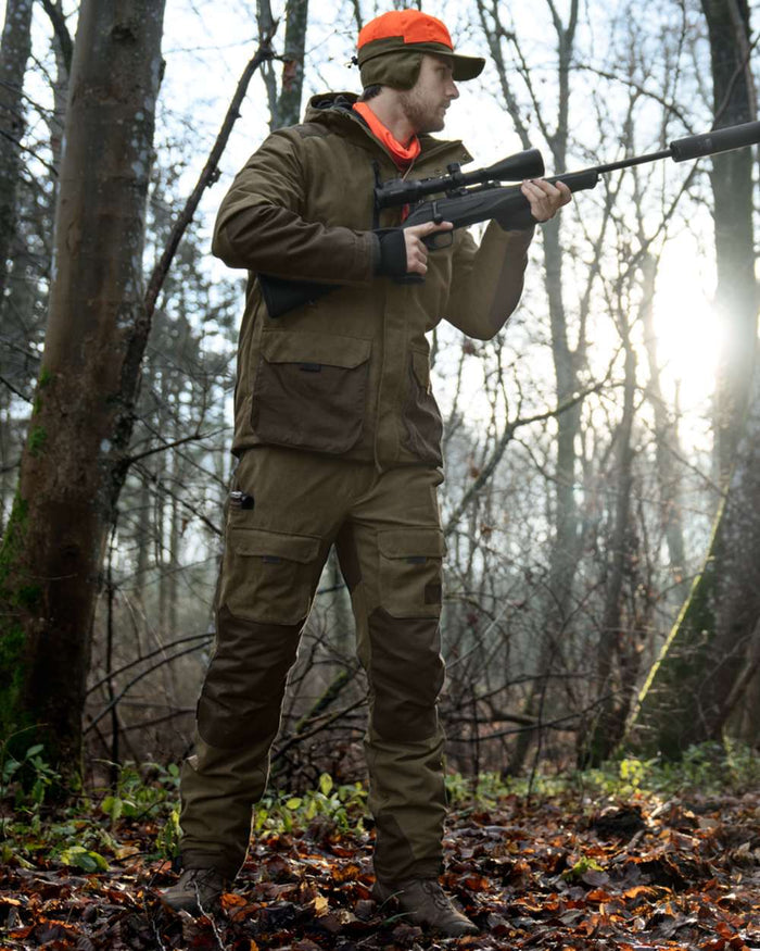 Grizzly Brown coloured Seeland Mens Ultimo Trousers on forest background #colour_grizzly-brown