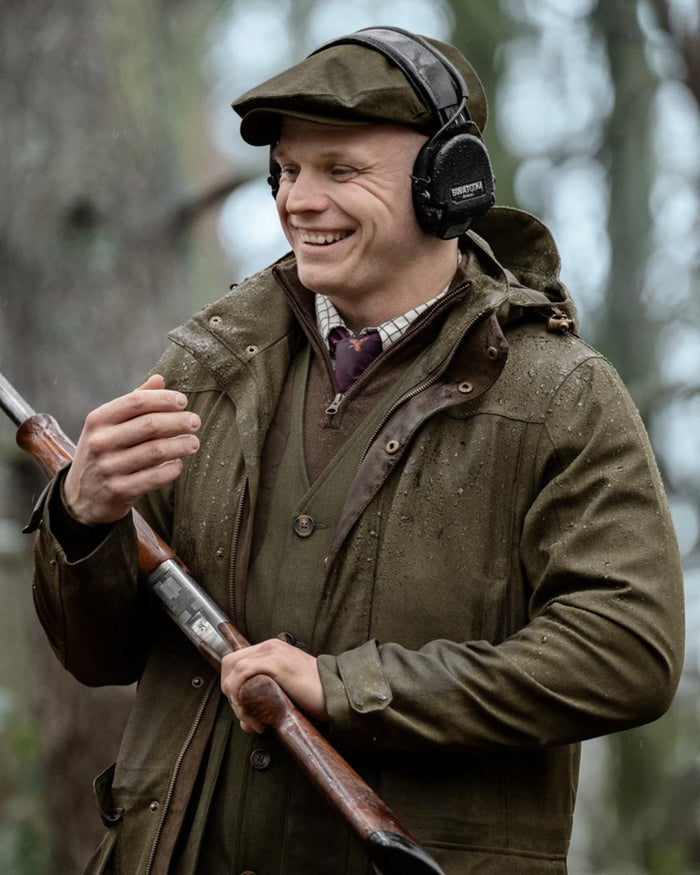 Shaded Olive coloured Seeland Mens Woodcock Royale Jacket on forest background #colour_shaded-olive