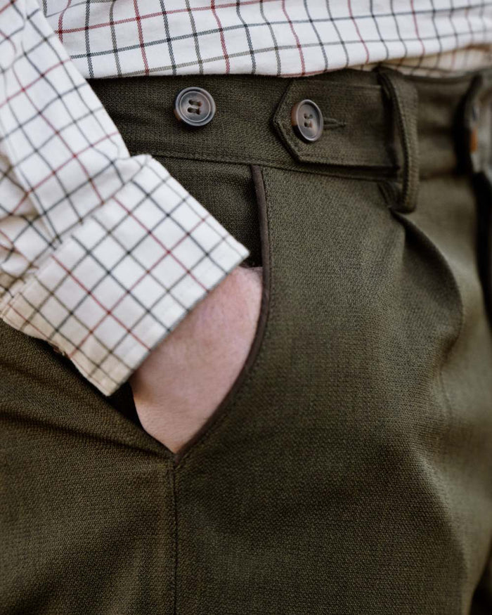 Shaded Olive coloured Seeland Mens Woodcock Royale Trousers on forest background #colour_shaded-olive