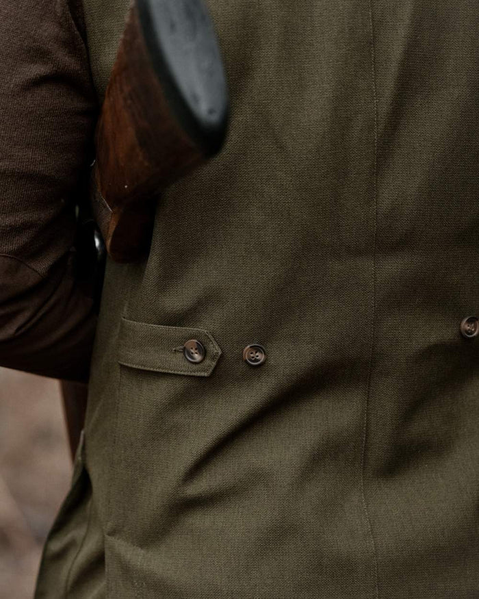 Shaded Olive coloured Seeland Mens Woodcock Royale Waistcoat on forest background #colour_shaded-olive
