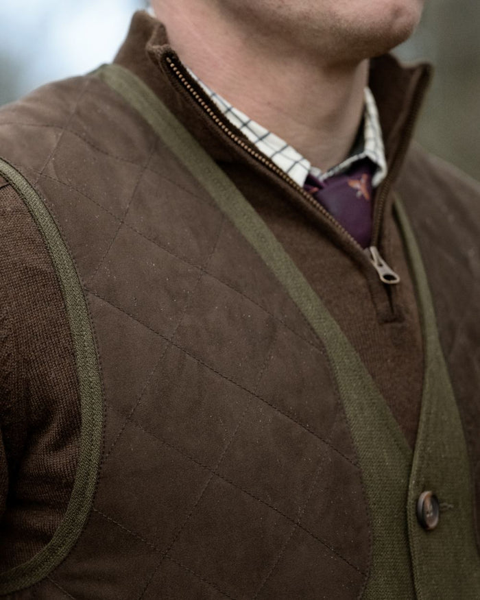 Shaded Olive coloured Seeland Mens Woodcock Royale Waistcoat on forest background #colour_shaded-olive