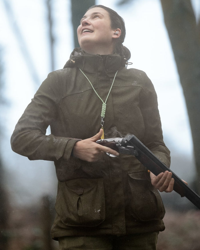 Shaded Olive coloured Seeland Womens Woodcock Royale Eve Jacket on forest background #colour_shaded-olive