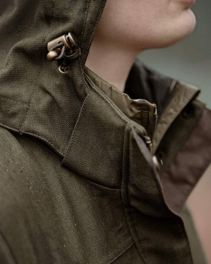 Shaded Olive coloured Seeland Womens Woodcock Royale Eve Jacket on forest background #colour_shaded-olive