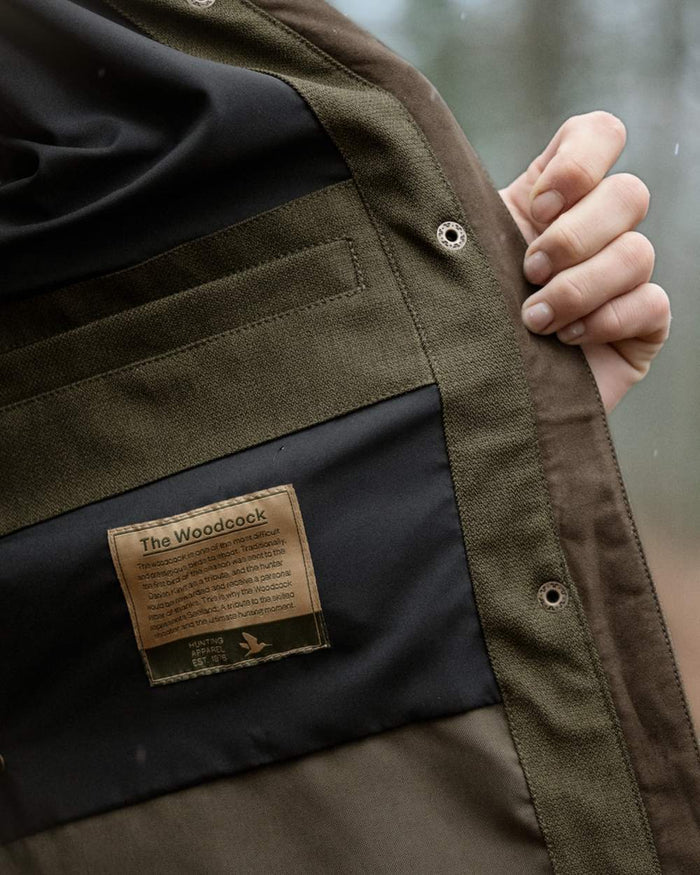 Shaded Olive coloured Seeland Womens Woodcock Royale Eve Jacket on forest background #colour_shaded-olive