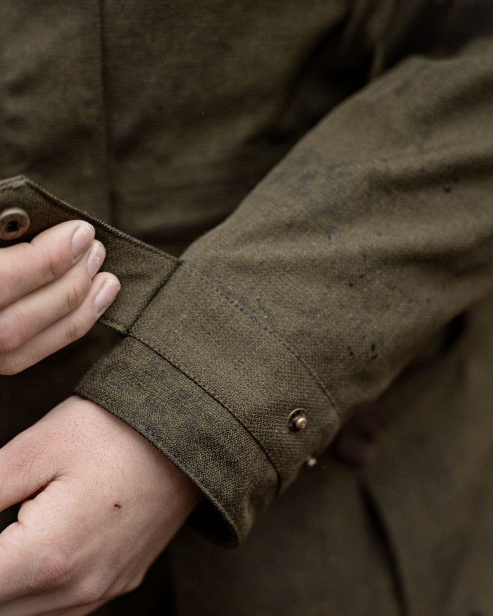 Shaded Olive coloured Seeland Womens Woodcock Royale Eve Jacket on forest background #colour_shaded-olive