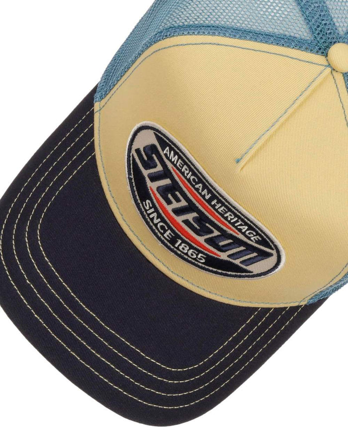 Midnight Blue Light Yellow coloured Stetson High Speed Trucker Cap on white background #colour_midnight-blue-light-yellow