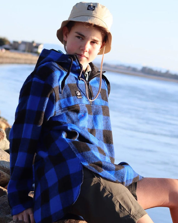 Blue Black Check Coloured Swanndri Kids Brixton Wool Bushshirt on sea background #colour_blue-black-check