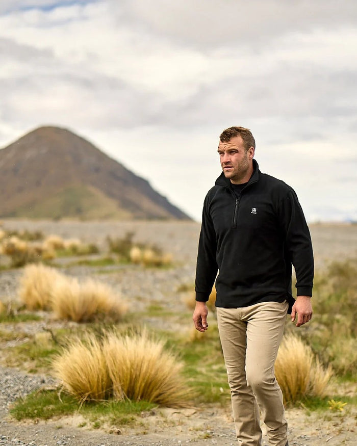 Black Coloured Swanndri Mens Motu Fleece Pullover on mountain background #colour_black