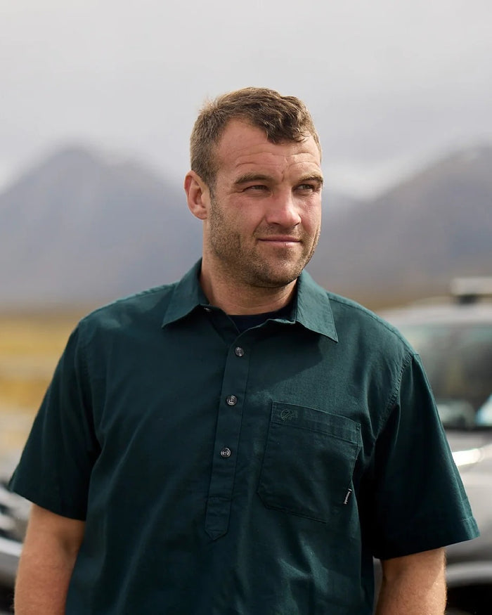 Forest Green Coloured Swanndri Mens Paihia Short Sleeve Shirt on blurry background #colour_forest-green