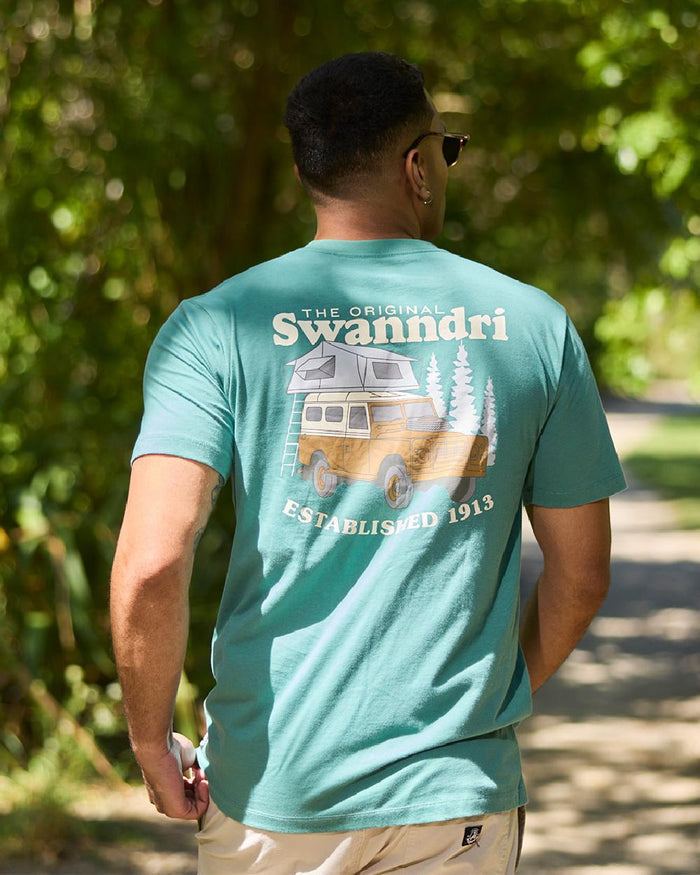 Jade Green Light Taupe Coloured Swanndri Mens Pop Top Printed T Shirt on street background #colour_jade-green-light-taupe