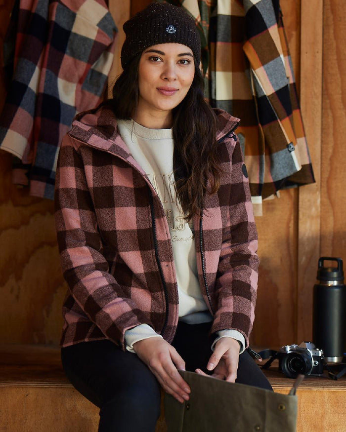 Rose Coffee Check Coloured Swanndri Womens Seattle V2 Wool Hooded Sweater on indoor background #colour_rose-coffee-check