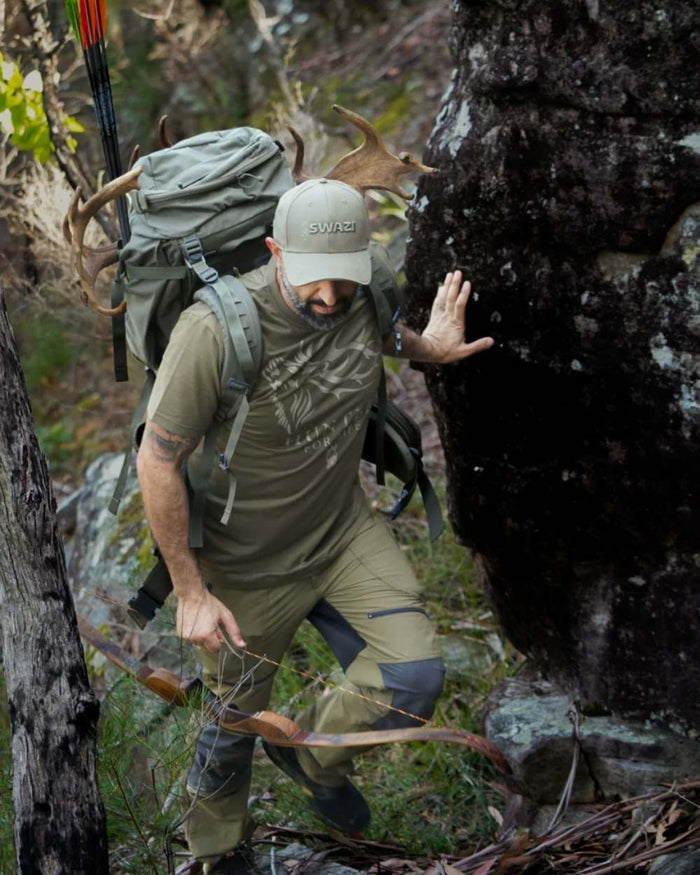Olive Coloured Swazi Mens Hunter For Life T-Shirt On A Forest Background #colour_olive