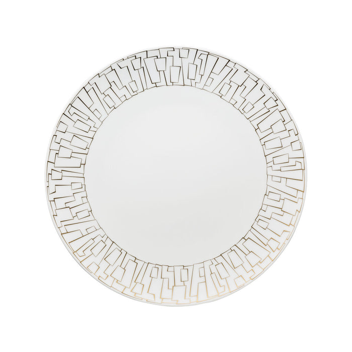 The Rosenthal Tac Skin Gold Dinnerware features a round white plate with a durable glaze and an elegant gold geometric rim, showcasing interconnected angular shapes on a sleek, plain background.
