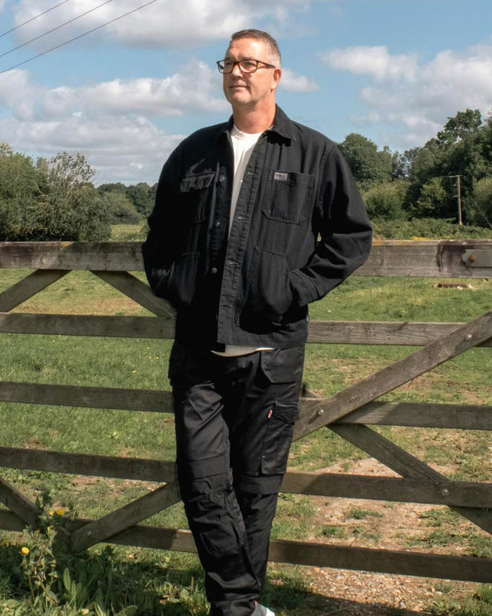 Black coloured TuffStuff Ranger Jacket on grassy background #colour_black