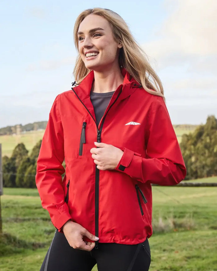 Bittersweet Coloured WeatherBeeta Jackson Waterproof Jacket On A Hill Background #colour_bittersweet-red