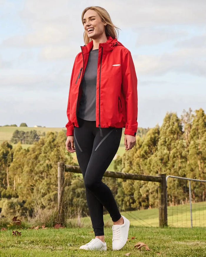 Bittersweet Coloured WeatherBeeta Jackson Waterproof Jacket On A Hill Background #colour_bittersweet-red