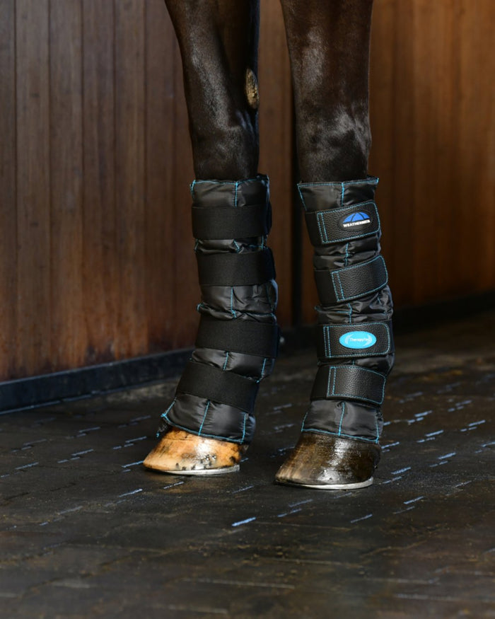Black Coloured WeatherBeeta Therapy-Tec II Gel Ice Boots on outdoor background #colour_black