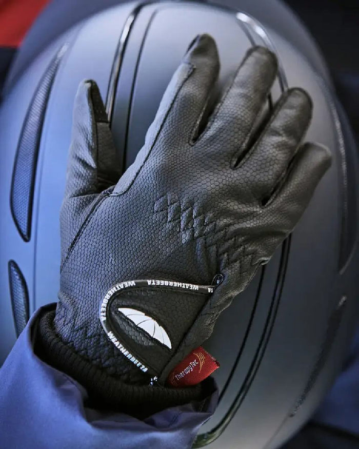 Black coloured WeatherBeeta Therapy-Tec Riding Gloves on helmet background #colour_black