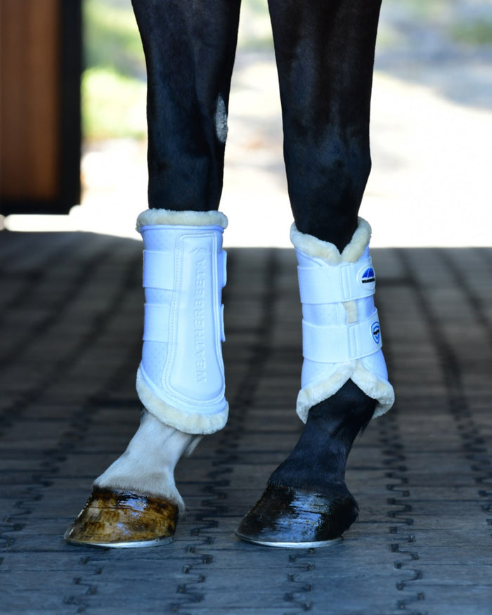White Coloured WeatherBeeta Tough-Tec Comfy Fleece Brushing Boots on horse background #colour_white