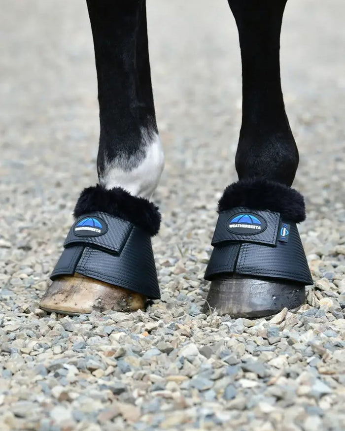 Black Coloured WeatherBeeta Tough-Tec Fleece Trim Bell Boots on horse background #colour_black