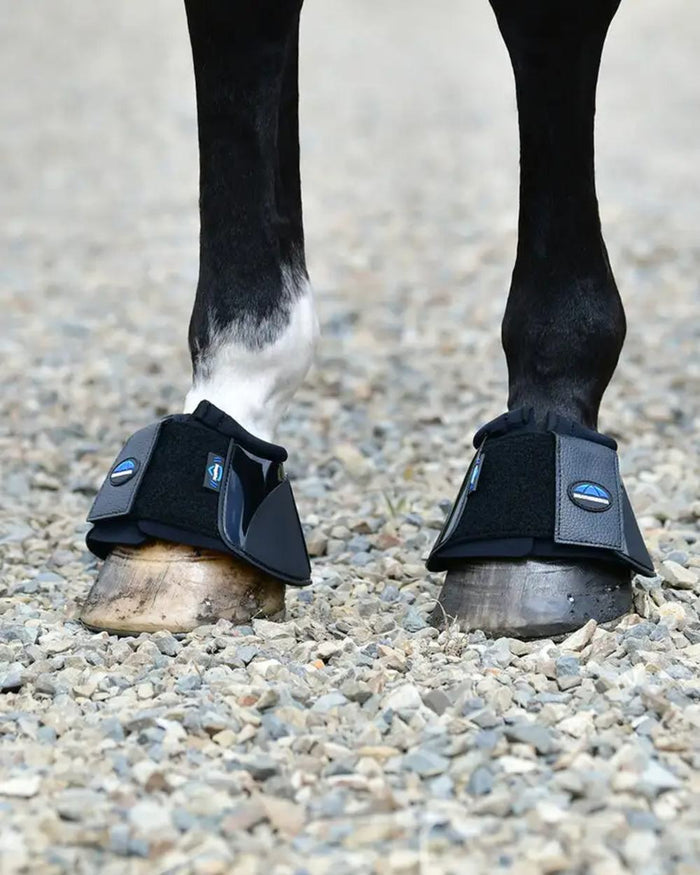 Black Coloured WeatherBeeta Tough-Tec Impact Bell Boots on horse background #colour_black