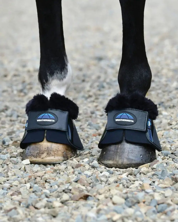 Black Coloured WeatherBeeta Tough-Tec Impact Fleece Trim Bell Boots on horse background #colour_black