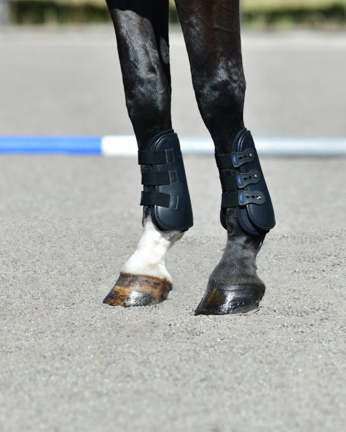 Black Coloured WeatherBeeta Tough-Tec Pro Open Front Boots on horse background #colour_black