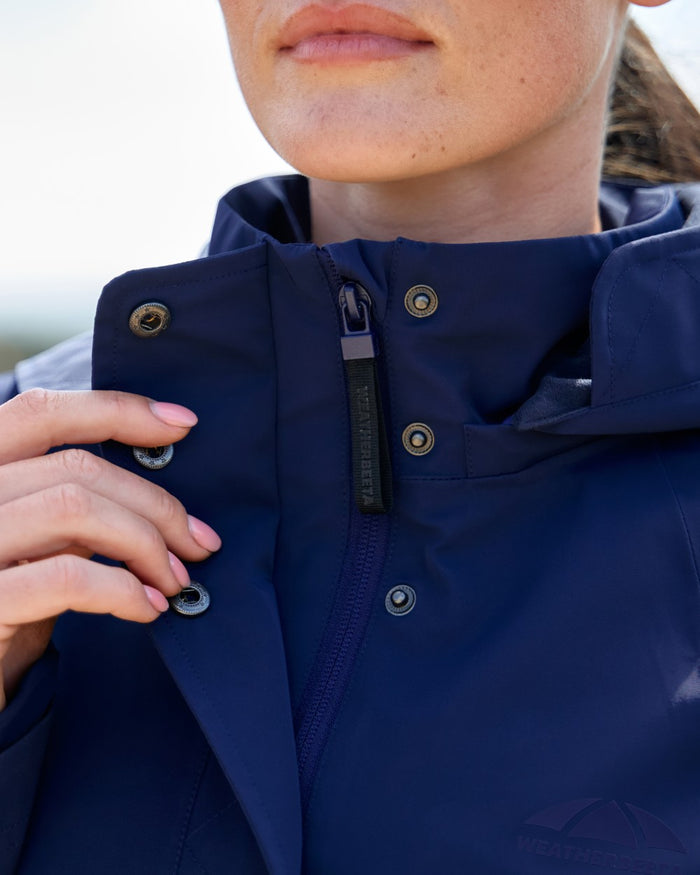 Navy coloured WeatherBeeta Womens Protect Waterproof Riding Jacket on outdoor background #colour_navy