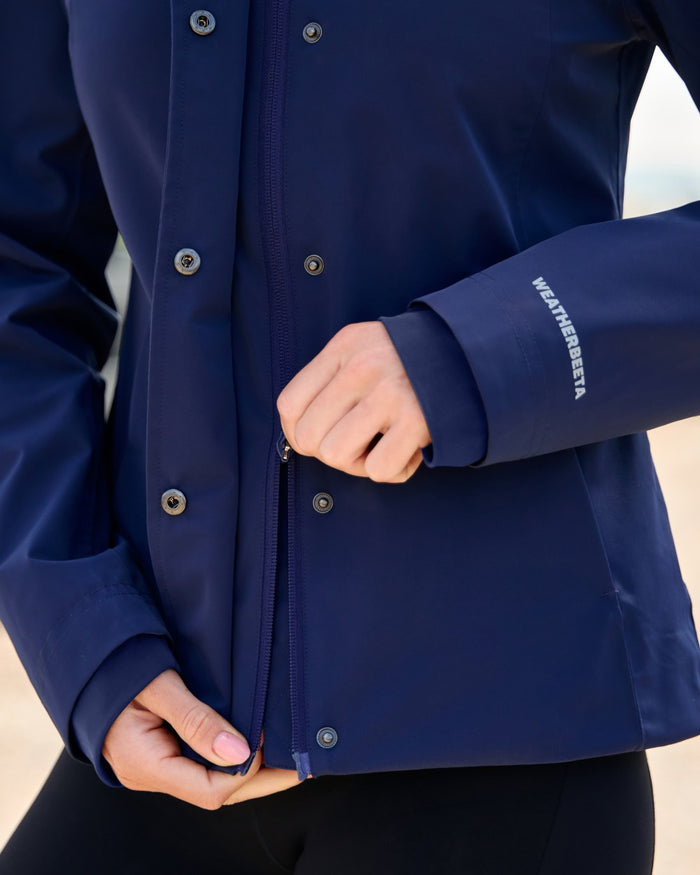 Navy coloured WeatherBeeta Womens Protect Waterproof Riding Jacket on outdoor background #colour_navy