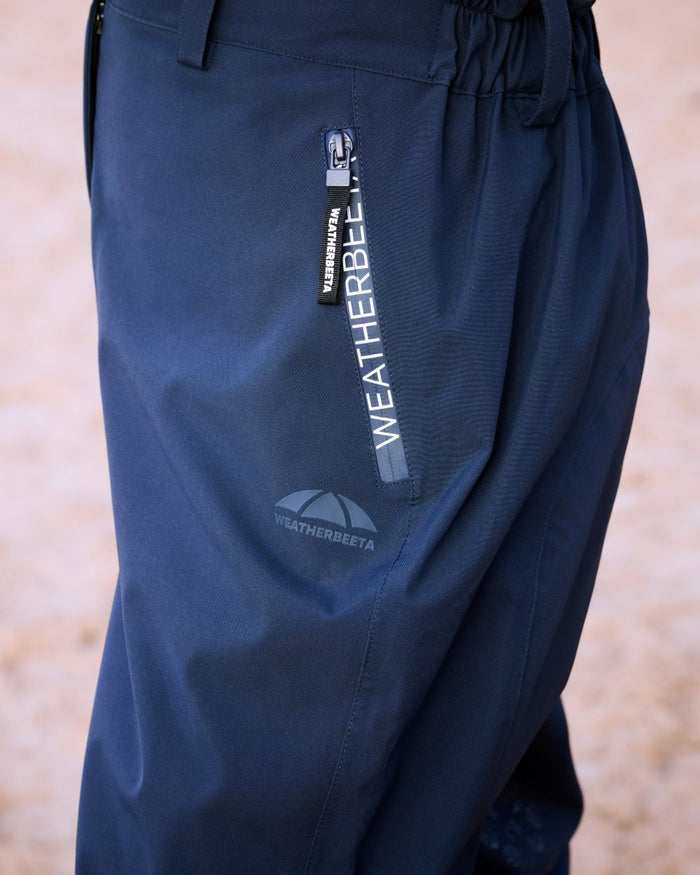 Navy White Coloured WeatherBeeta Womens Rayne Waterproof Overtrousers II on outdoor background #colour_navy-white