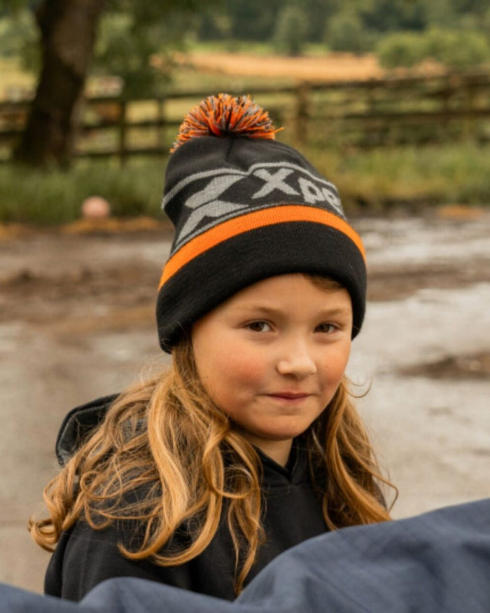 Black Coloured Xpert Children Pom Pom Beanie Hat on Outdoor Background
#colour_black