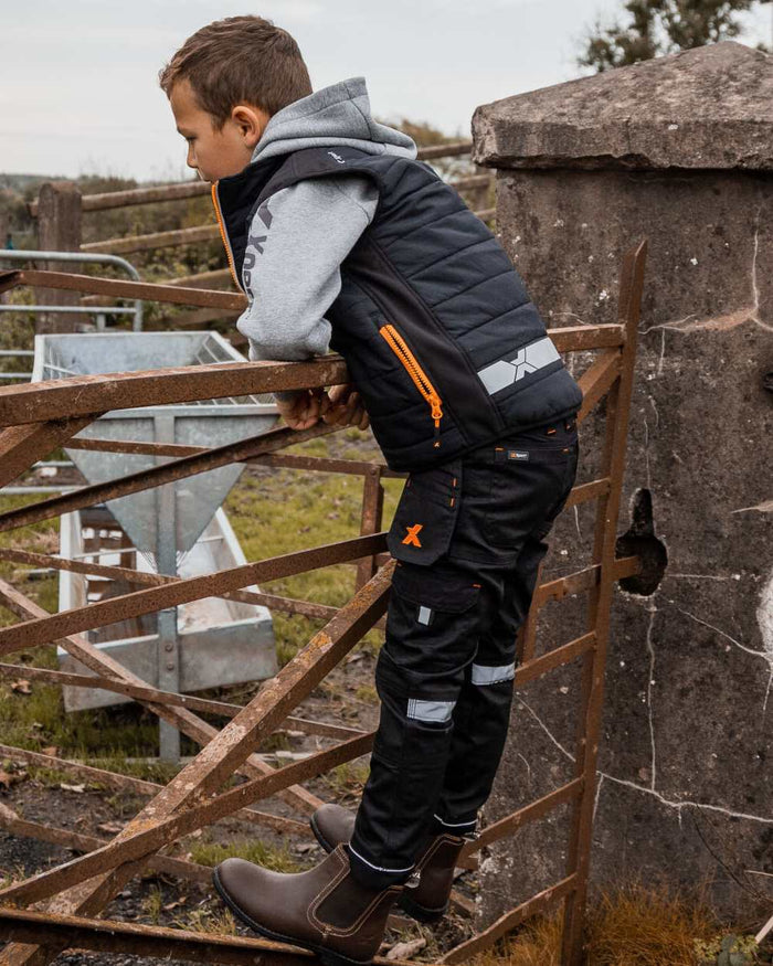 Black Coloured Xpert Children Pro Stretch Work Trousers on Outdoor Background
#colour_black