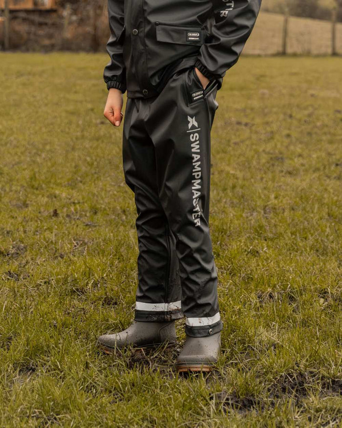 Navy Coloured Xpert Boys Swampmaster No-Sweat Stormgear Junior Waterproof Trousers on Outdoor Background
#colour_navy