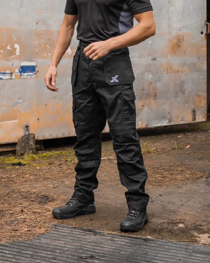 Black Coloured Xpert Mens Core Work Trousers on Outdoor Background
#colour_black