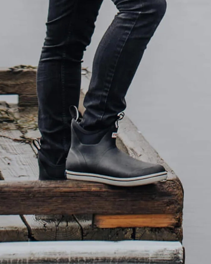 Black Coloured Xtratuf Mens Trolling Pack Fleece Lined Ankle Deck Boots on outdoor background #colour_black